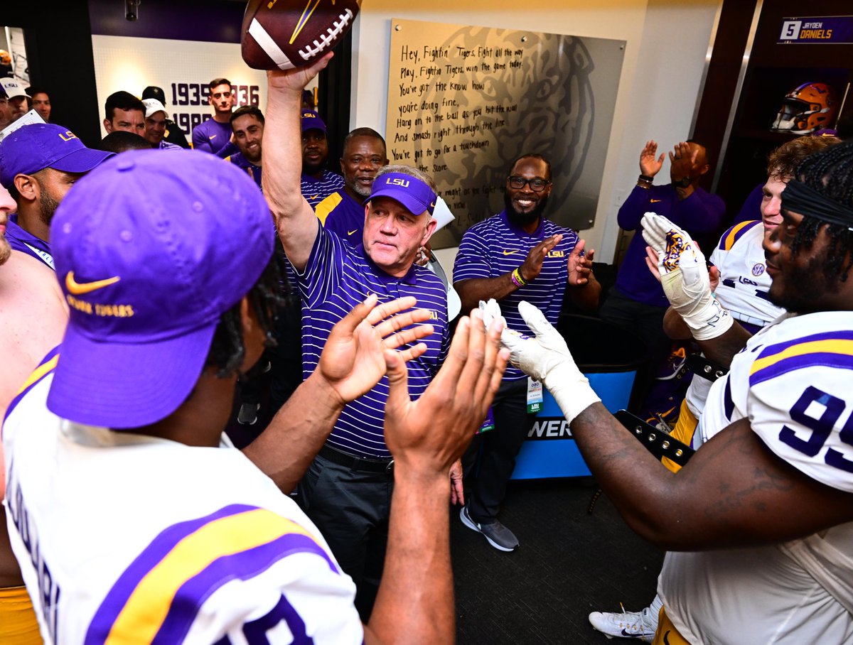 The team presented Coach Kelly the game ball after his first win as head coach.