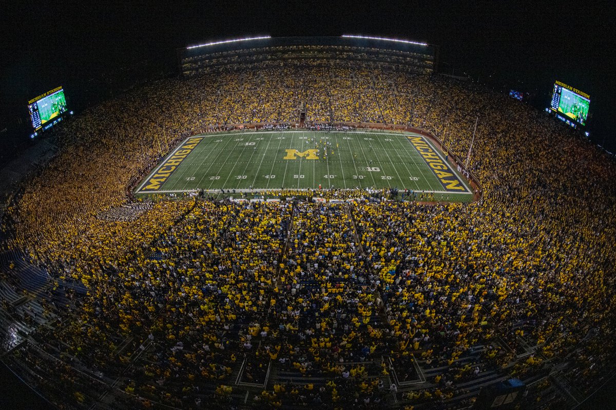 Michigan Stadium at night with a full crowd 