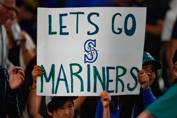 Fan holding a “Let’s Go Mariners!” sign.