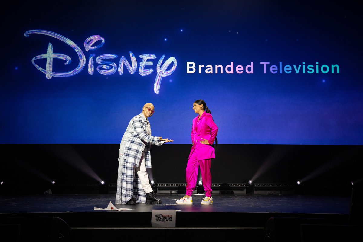 WaltDisneyCo's tweet photo. Yesterday at #D23Expo, Lilly Singh and Raven-Symoné hosted a special presentation previewing Disney Branded Television's exciting slate of films and series, highlighted by special performances, surprise announcements, and more: https://t.co/5oKFZNgqco https://t.co/0swlvXYnE4