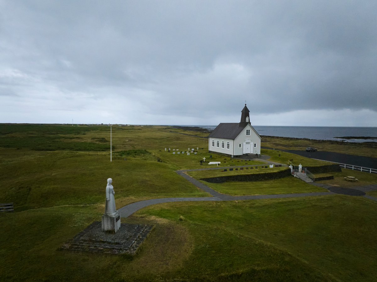 Judge_Burgess's tweet photo. Recently spent a rainy morning at #Strandarkirkja ("Beach Church") on the south coast of #Iceland, built where in legend an angel guided a group storm-tossed sailors through the surf and into a sheltered bay. It is watched over by a granite sculpture of the angel. Cool. ๐ท๐จโโ๏ธ๐ฎ๐ธ https://t.co/mhL8SyVYPZ