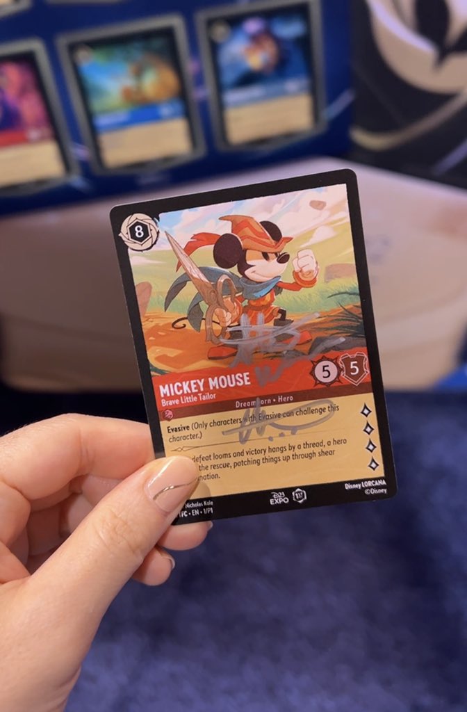 I don't really know much about the Disney Trading Card game Lorcana but I  think two of the artists signed my card at D23??