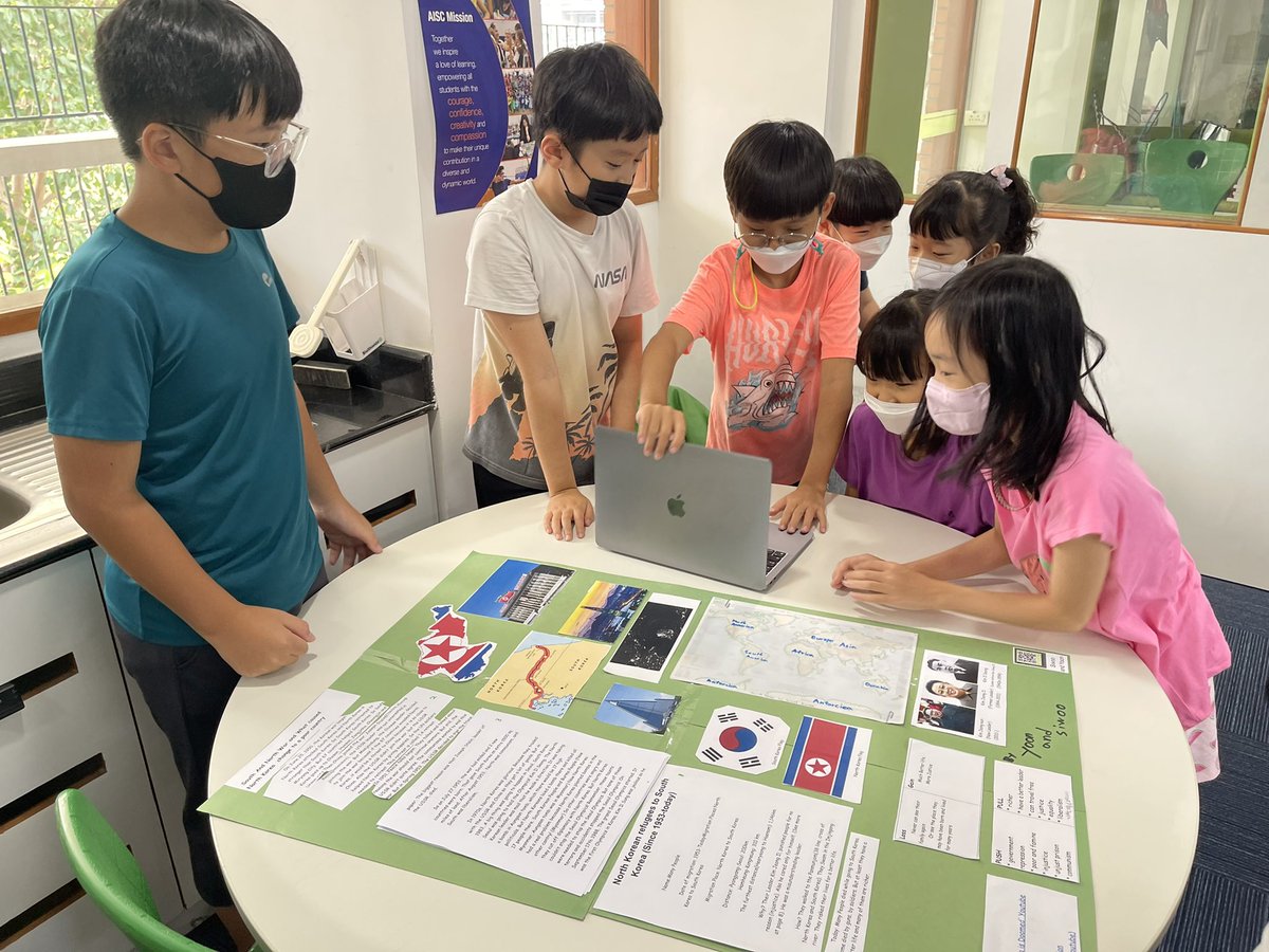 AISCElementary's tweet photo. So surreal to have moments like these back on campus!Fifth graders sharing their research on human migration with an enthusiastic second grade bunch! 2MS learned what it means to present an artifact at a museum from the expert 5BT docents. #AISCGrade2 #AISCElementary #AISCGrade5 https://t.co/FV5t6PXl5i