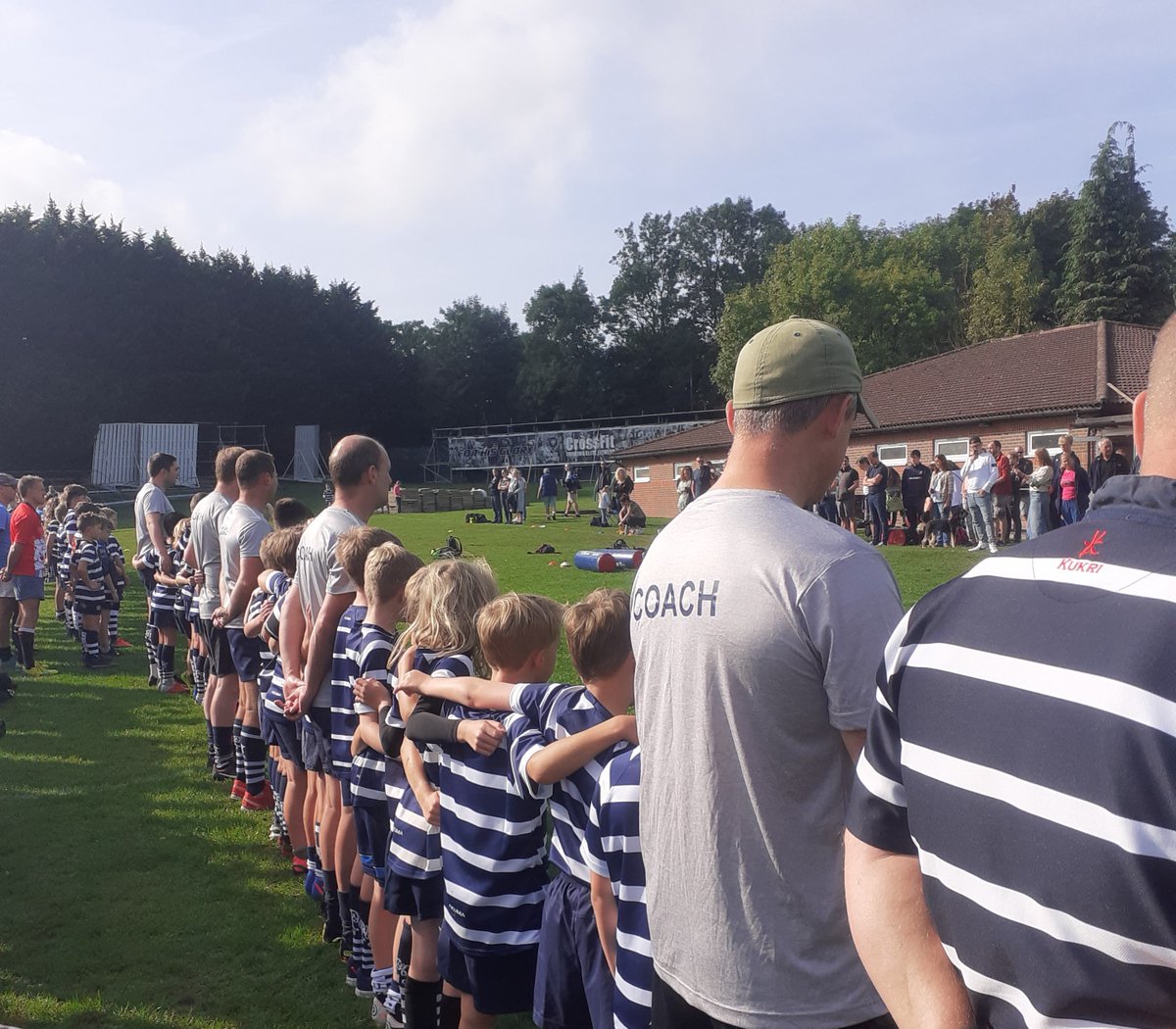 RugbyMinis's tweet photo. Combe Mini and Junior players, parents, family members and supporters participating in a one-minute silence in front of the clubhouse on Sunday morning to remember the Queen. https://t.co/EQTOxZH334