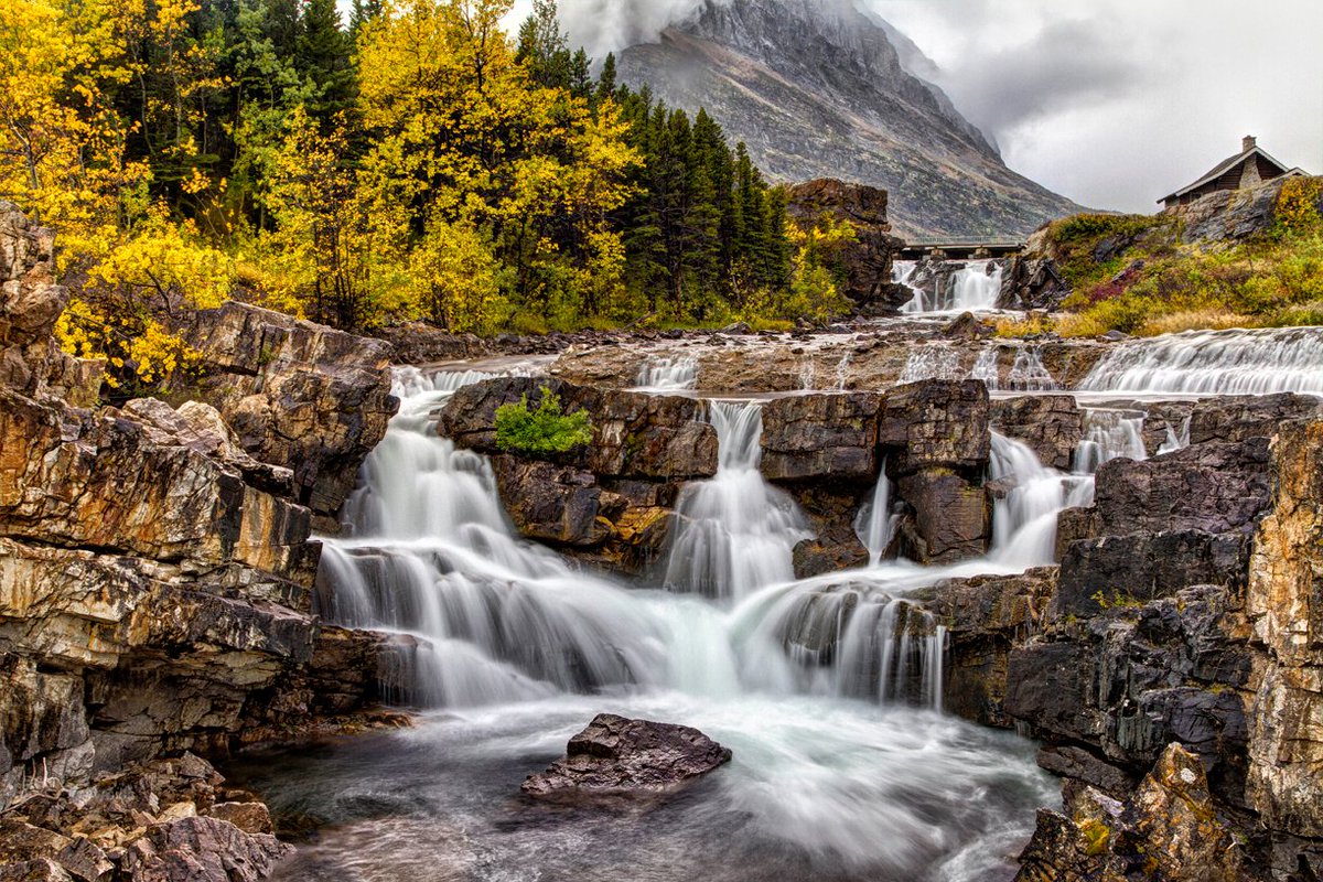 Swiftcurrent Falls flanked in Autumn colors. Find it here: bit.ly/3xgZlR7 #FallForArt #Buyintoart #GlacierNationalPark #AutumnVibes #Autumnphotography #Photgraphylovers #Homedecor #MontanaLandscape