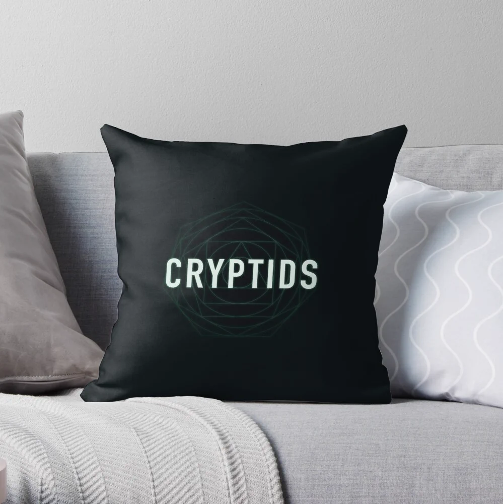 A mockup from Redbubble. A throw pillow has the Cryptids logo on it.