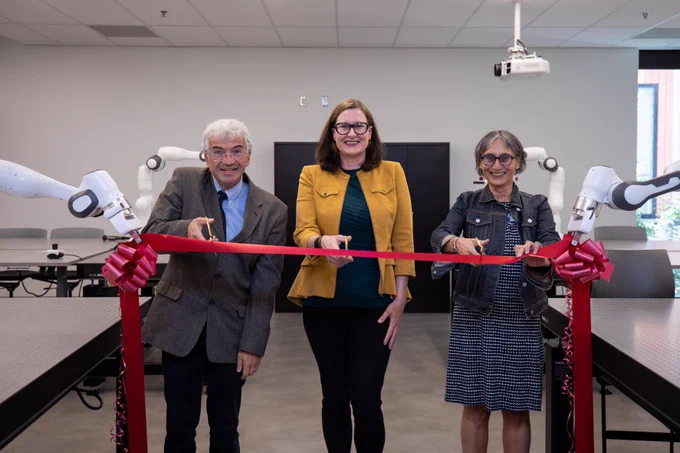 Ribbon-cutting ceremony at robotics laboratory.