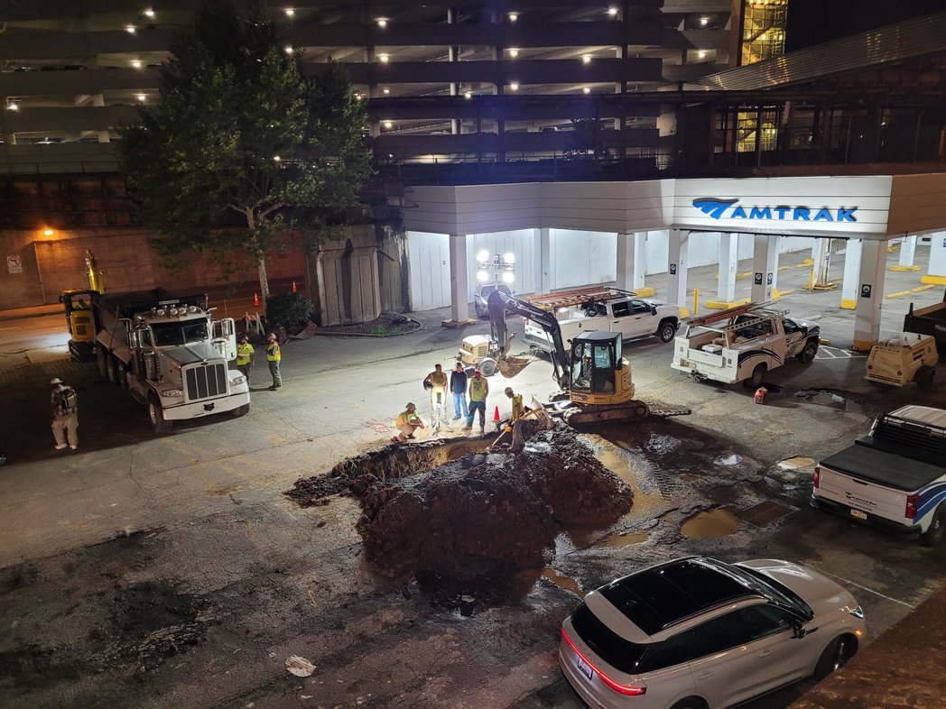 🚨ALERT🚨 Someone is finally fixing the jacuzzi-sized holes in the Pittsburgh Amtrak station's parking lot!!! (Amtrak station folks once told me that this parking lot belongs to the Pennsylvanian apartments next door and they couldn't do anything about it themselves! 🤷‍♀️)