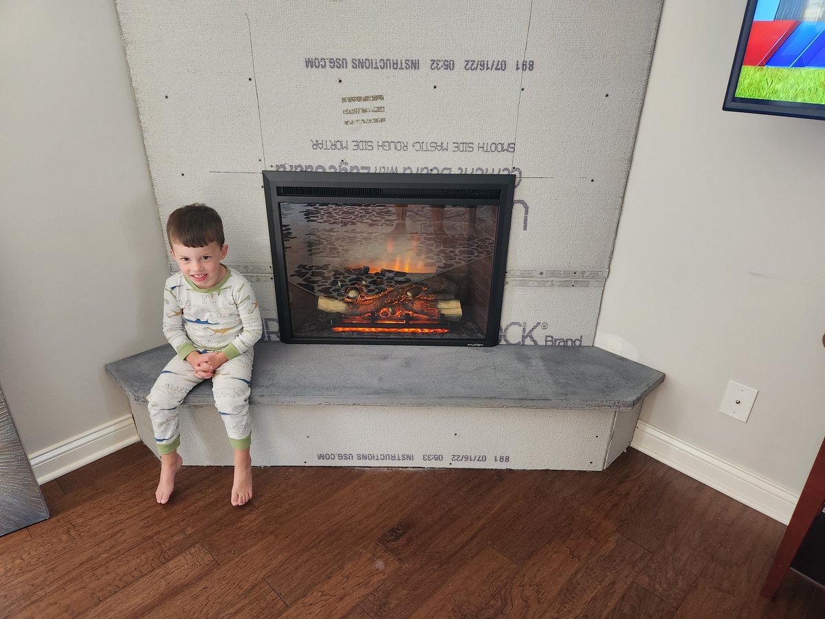 The concrete hearth is in its final resting place. 👌👌And it's a perfect fit!👌👌 Little man is as excited as I am! 💯🔥💯🔥#hearth #concretehearth #diyfireplace #diy #diydad #fireplace #fireplacebuild