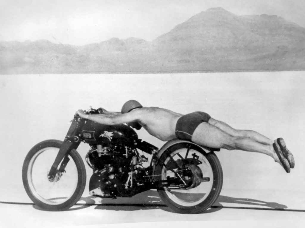 That's Rollie Free, gas station manager, on this day in 1948 doing 150mph on a Vincent Black Lightning. Covered the first mile in 24 secs, wearing swimming trunks and lying flat to reduce drag. On the return run he swapped the helmet for a swimming cap and went a bit faster. FFS.