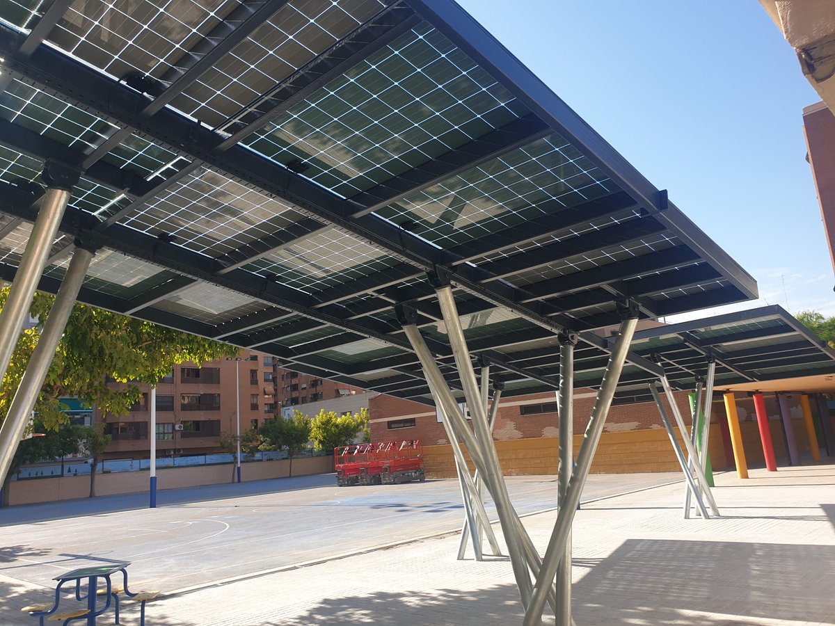 1/2. The #SantiagoGrisolia School, in Valencia (Spain), now enjoys PV canopies made in crystalline silicon glasses in the playground of the school. The glasses are manufactured with a high density of cells to prevent the light entrance while providing the max. peak power per sqm