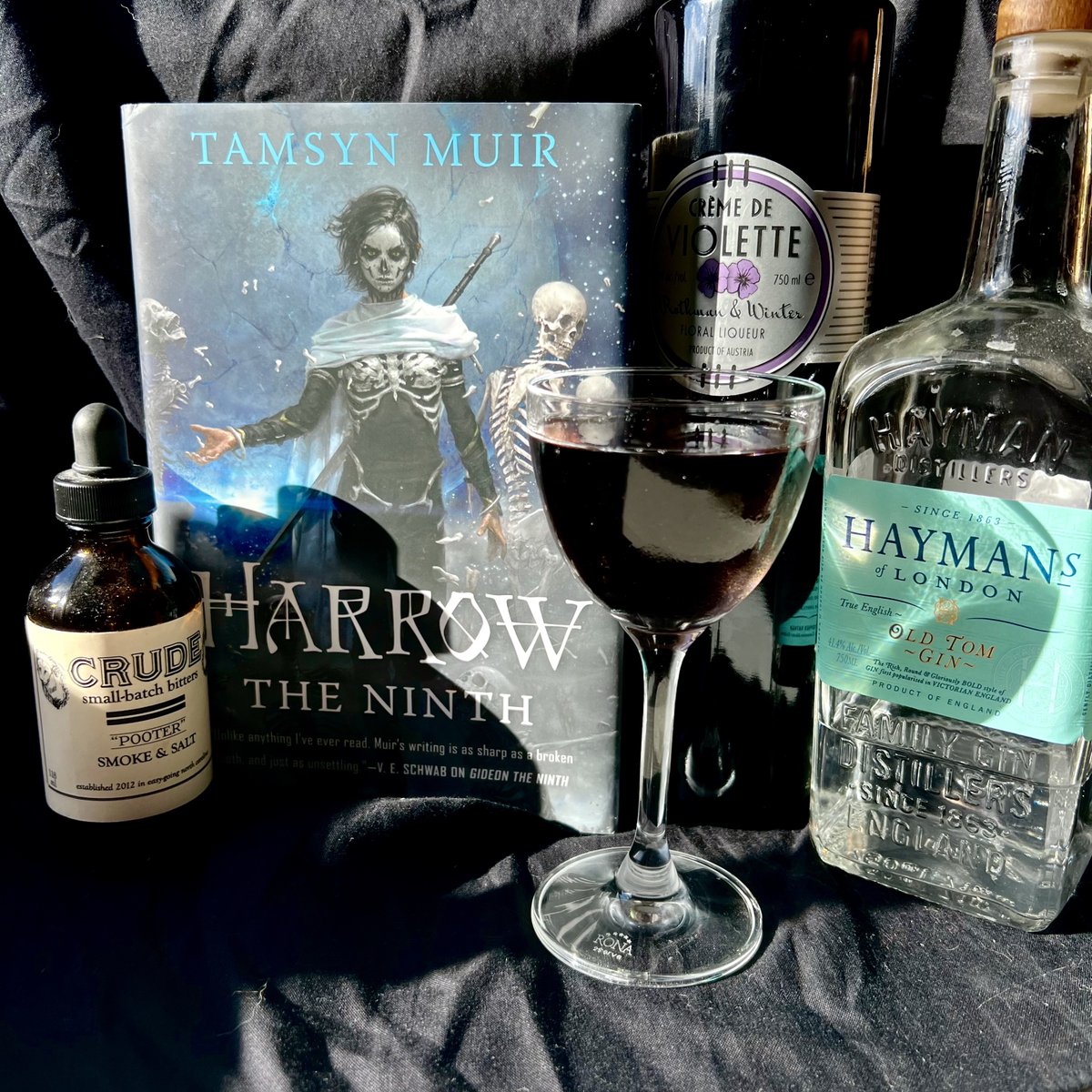 EliasEells's tweet photo. Today on Bar Cart Bookshelf, we're talking about #HarrowTheNinth by Tamsyn Muir! The second book in #TheLockedTomb series, Harrow is a phantasmagoric portrait of grief and duty. Our drink, The Ninth Saint, is floral &amp; austere, well-suited to the silent halls of a space mausoleum. https://t.co/FZfzZjC3X2