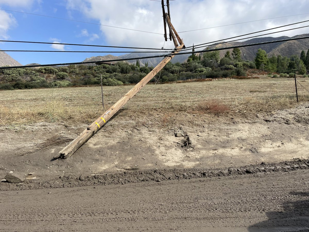 weatherechowx's tweet image. Power poles snapped by water with boulders and hanging wires #debrisflow