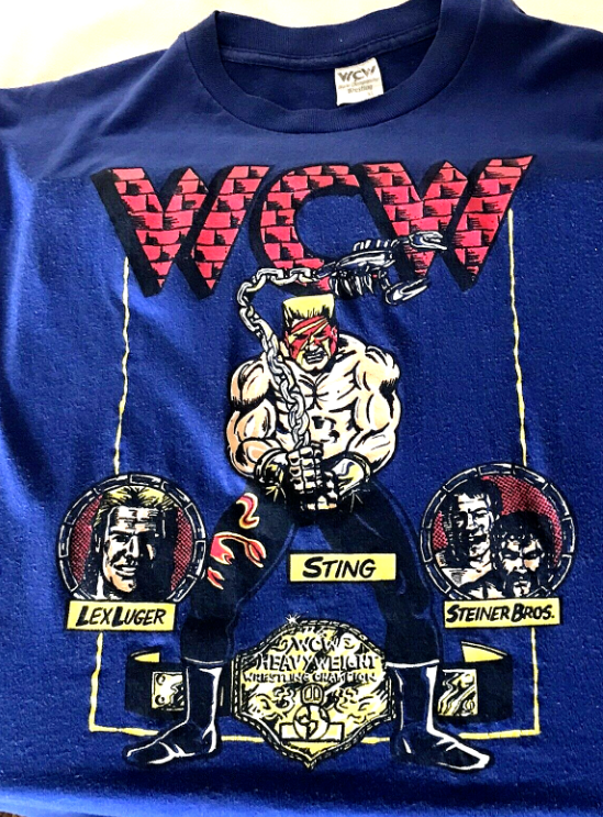 WCWTFPodcast's tweet photo. #WCWWorstMerch @Sting @AEW @AEWonTV
 
Man, how are we going to sell this shirt?

I know, let's combine two things that kids love!

Comic books and S&amp;M! https://t.co/vXAlGTOkib