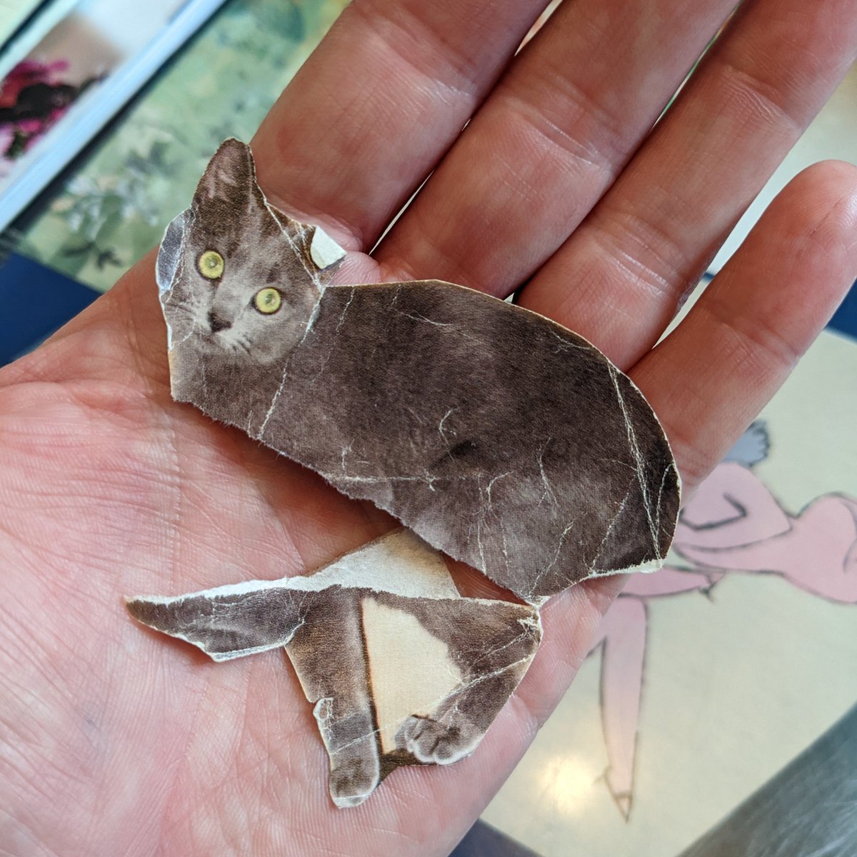 LadyAttercop's tweet photo. RIP to this cutout of a gray cat that's been taped to @theBeehiveSalon's receipt printer almost as long as I've worked here. https://t.co/jmtsyLjREx