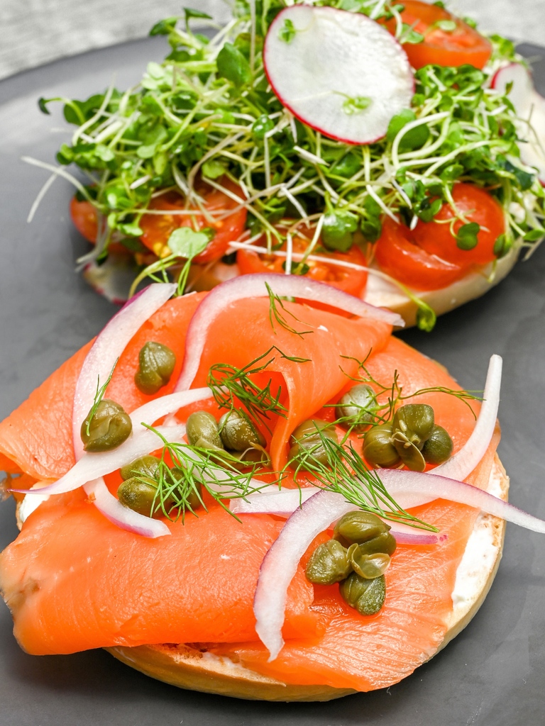 Fully loaded Salmon Bagels for brunch! 🥯 Sustainable smoked Ora King salmon, cream cheese, dill, red onions, and capers on an open face bagel. Served with micro greens, cherry tomatoes, shaved radish, EVOO and salt 😋