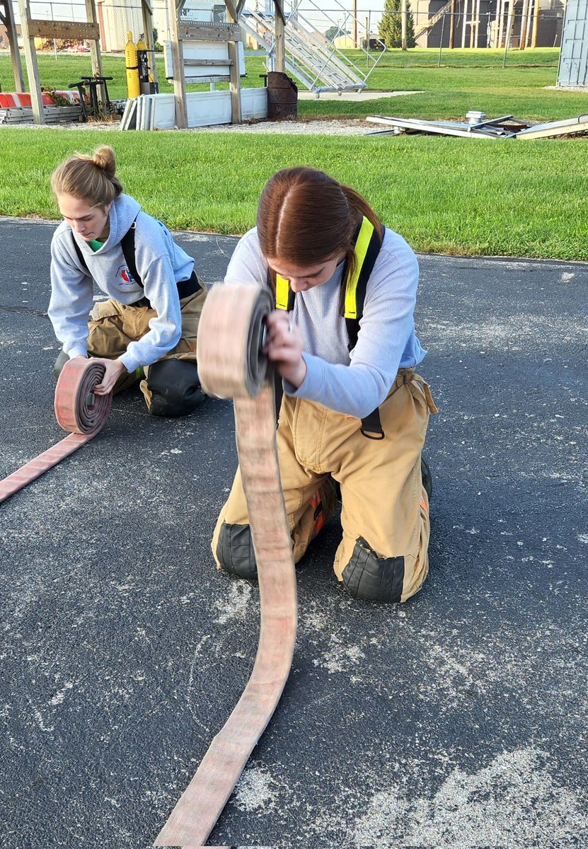 Company 1 students practicing hose rolls.
