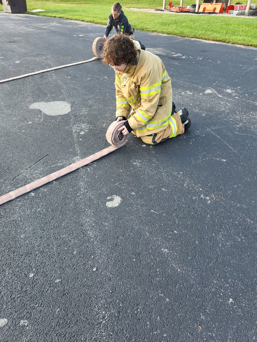 Company 4 students practicing hose rolls.