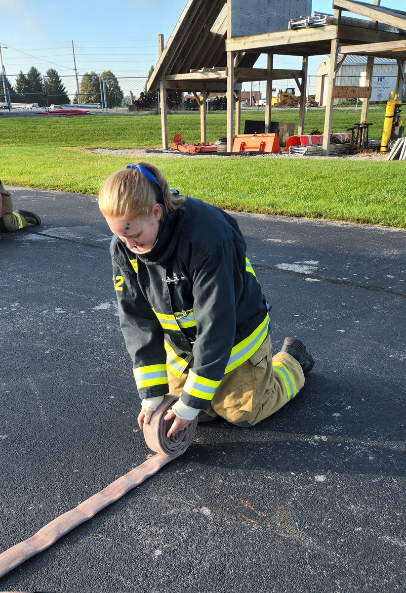 Company 3 students practicing hose rolls.