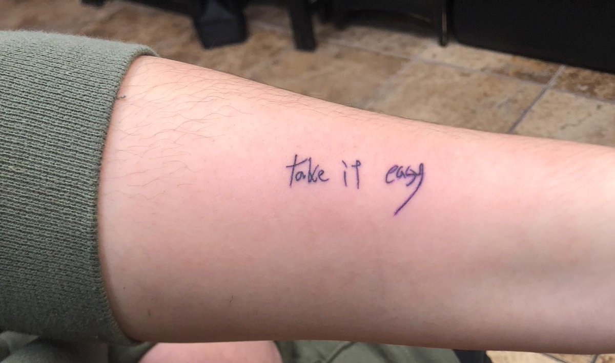 Take it easy lettering tattoo on the wrist