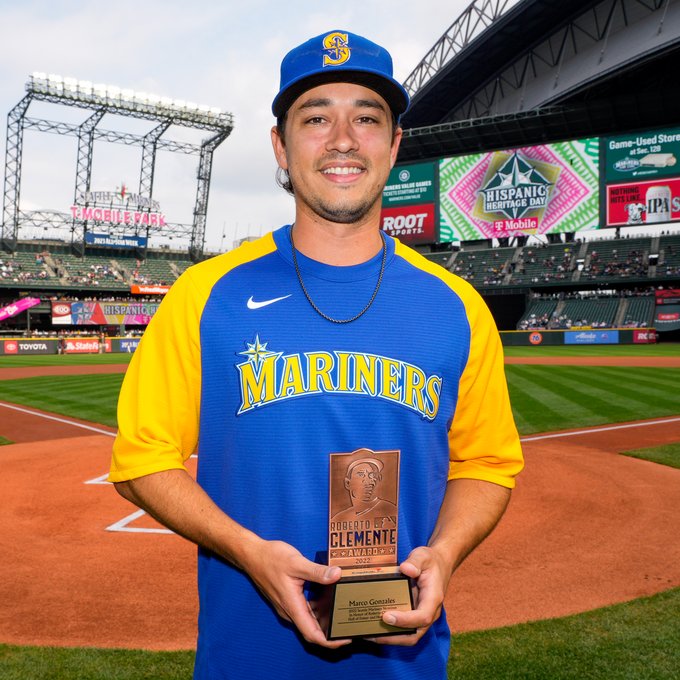 Marco Gonzales holding up his Roberto Clemente Award nominee trophy. 