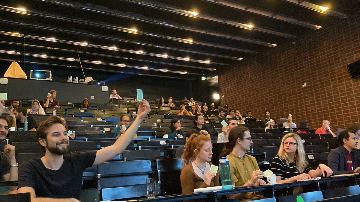 EmaMagnetism's tweet photo. Students are voting with cards - are bubble and skyrmion the same??? Each side is trying to convince the other 😆 @ESM_School #ESM2022 https://t.co/vXgH5wCNTw