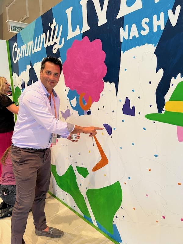 ETHERFAX's tweet photo. We're having a great time meeting everyone at #CommunityLIVE and demonstrating how you can replace fax with etherFAX! Our CEO and co-founder, Paul Banco, even had a chance to paint a portion of the CommunityLIVE mural. 🎨 @Hyland @pauliebanks https://t.co/odvOlGNPwv