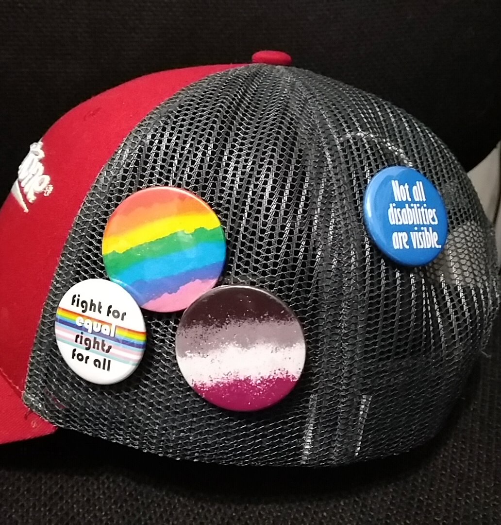 ErinTenelle's tweet image. I&apos;ve attached my new pins to my work hat from @IfsAndsOrButton to help me communicate not only my own pronouns but also that my workplace is intended to be a safe space!! Going with my pride and ace pins by @ParanoArt ! I&apos;ll leave comments on Etsy after work,these are 👌 perfect.
