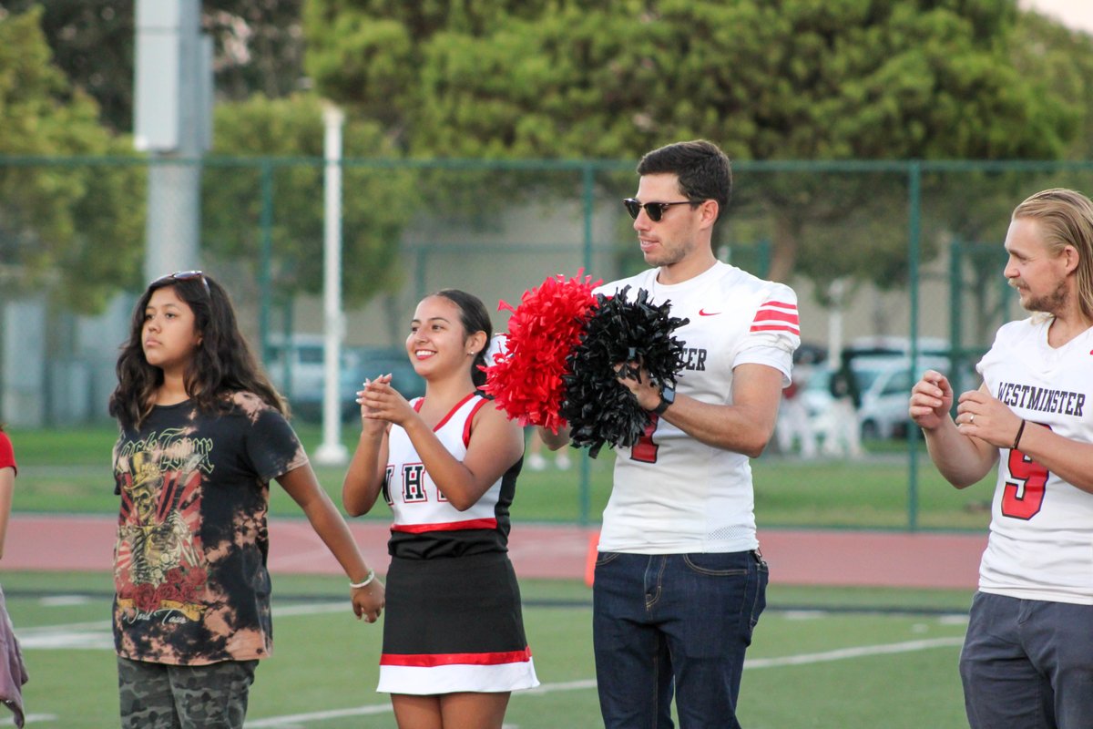 HBUHSD's tweet photo. Staff Appreciation Night was a success at last night's Westminster football game! We love the enthusiasm from Principal Sabol, and it's incredible to see all of our WHS staff members out on the field wearing jerseys and supporting their team! #OneFamilyOnePride.❤️🖤🦁 https://t.co/tJGySQXcZt