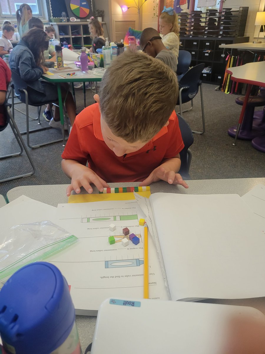 Look at these 2nd graders concentrate while making their own centimeter rulers!  I love the hands on approach of our new math program!