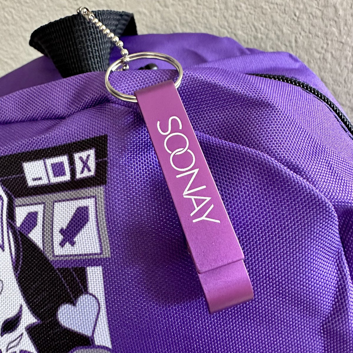 valorandvellum's tweet photo. Hop onto the #Soonay train with this fun streamer inspired backpack! It’s LE 40, $50, comes with a free bottle opener keychain, and it’s exclusive to #TwitchCon2022. Baby got backpack! https://t.co/8WWWYNbL3i