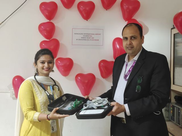 Dr Nishitha Rai M, medical officer, APHO receives the portable ECG machine from MIA leadership on World Heart Day.