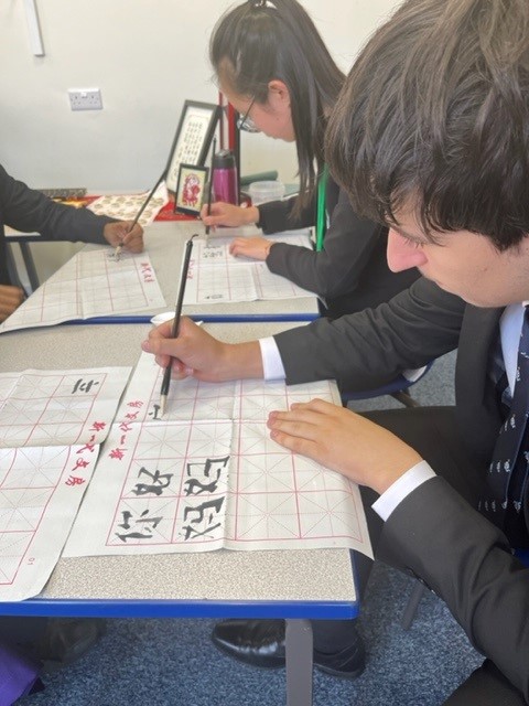 WhitgiftSchool1's tweet photo. Students are practising writing Chinese characters using traditional Chinese brushes and creating name badges in Japanese script in Whitgift's Oriental Languages room. #WhitgiftLanguages #WhitgiftOpenEvening2022 https://t.co/DYjcq5B7iC