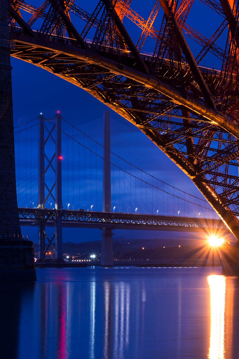 3 bridges...a train sharing its lights...and the cool blue gloaming sky

<a href="/TheForthBridges/">The Forth Bridges</a> 
#ForthBridge
#Scotland