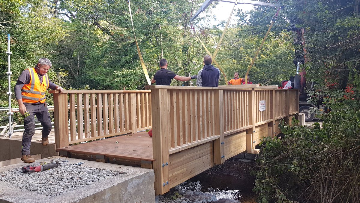 GlengarriffWood's tweet photo. Update: our new footbridge was lifted into place yesterday. The next stage is installing the steps &amp; multi-access ramps. It's is due to be finished by early Nov when we look forward to seeing people using what we hope you'll agree is a beautiful bridge! #woodlands #amenity https://t.co/gGYDYgEhnT
