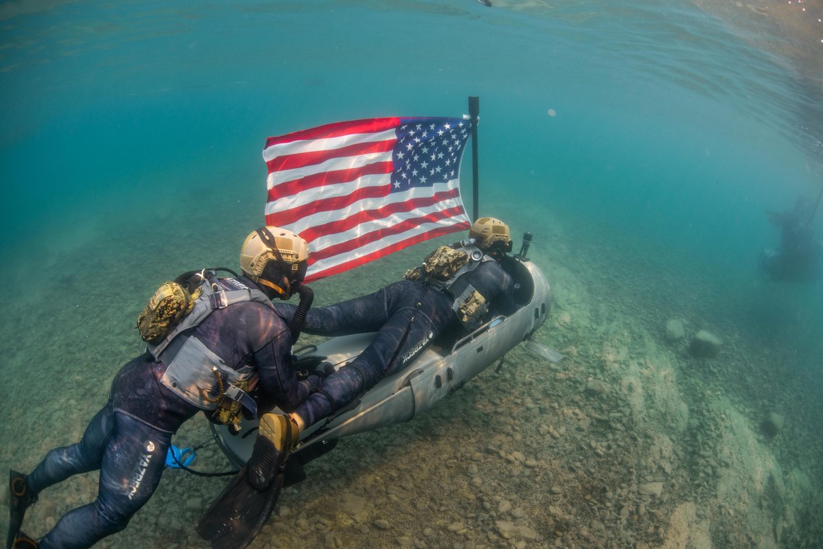The flag flies everywhere 🇺🇸. 

<a href="/USNavy/">U.S. Navy</a> sailors assigned to various Naval Special Warfare commands operate a diver propulsion device during high-altitude dive training in northern California.
