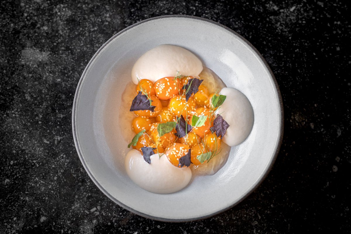 Sungold Tomatoes with chilled tomato dashi and sesame tofu, shown here, is an exploration of late summer flavors and surprising texture. Join us 60 floors up manhattarestaurant.com/reservations/