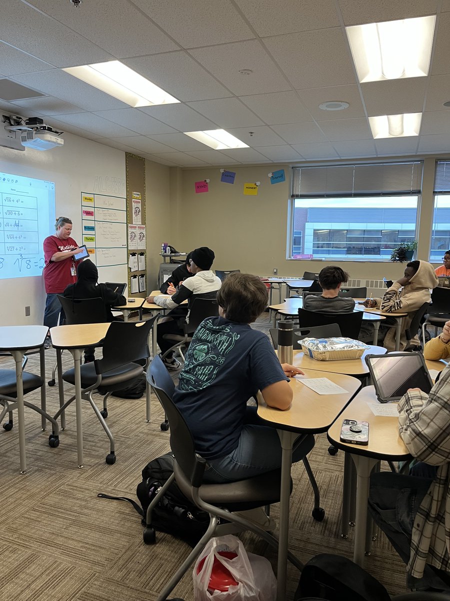 Students are talking about how they solve math problems. "Unpacking" their thinking, discussing steps, and solving problems together with Ms. Chmilding in Algebra. <a href="/usd469/">Lansing USD 469</a> #ProudofthePride