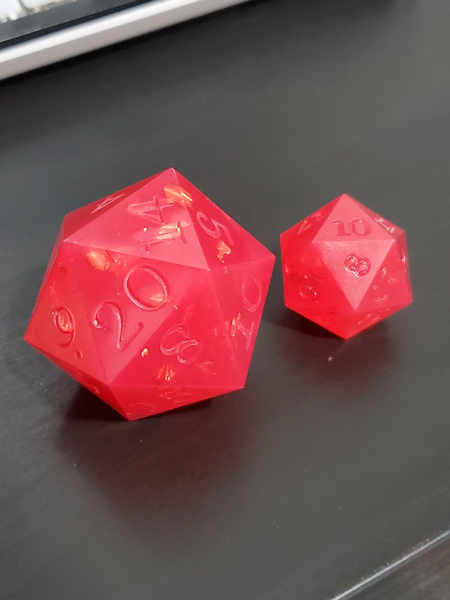 CritCandyDice's tweet photo. I made this weird... strawberry chonk as kind of a throw-away "gonna sand you down into a blank" thing and now that it's just hanging out, I'm not sure how I feel about it anymore. Anybody else ever make a die you think you're gonna hate but then you Don't? https://t.co/Kqtxk7ODuk