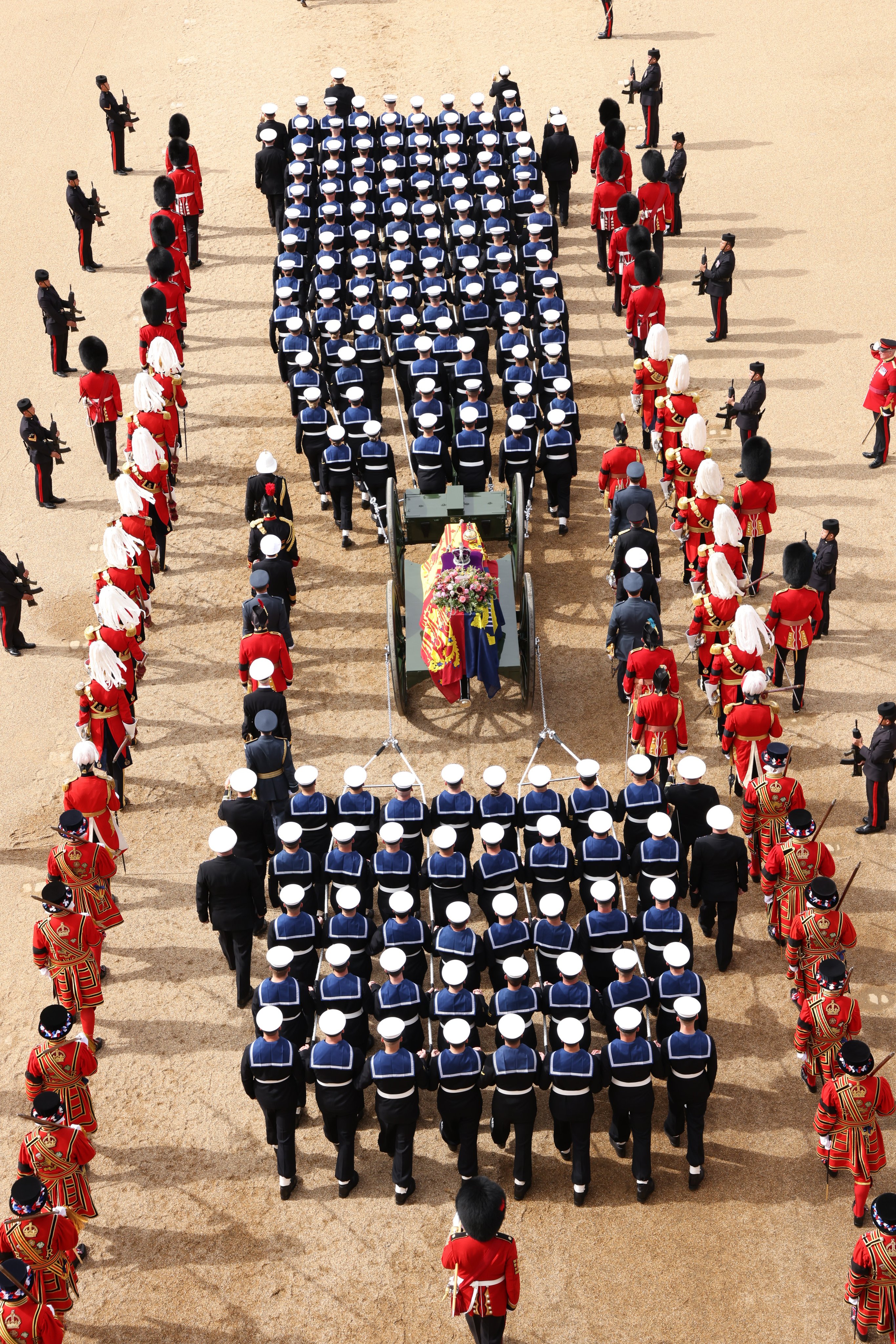 HM Armed Forces lead the procession for Her Majesty The Queen's coffin from Westminster Abbey.