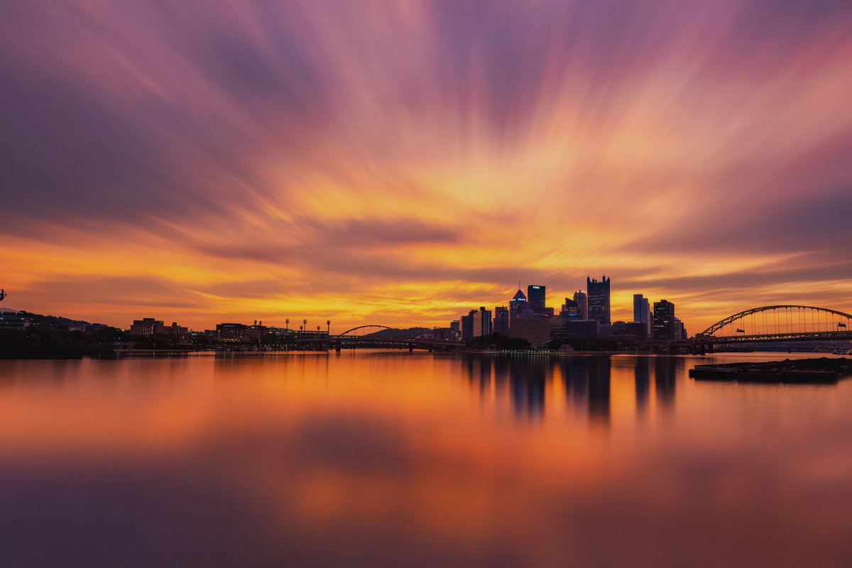 DaveDiCello's tweet photo. It made be raining now, but sunrise in #Pittsburgh was actually pretty awesome today. This is a 244 second exposure, captured with a neutral density filter, showing how far the color spread across the sky. The reflections weren't too bad either. I'll take that for a Monday. https://t.co/jLMYMO7KYD