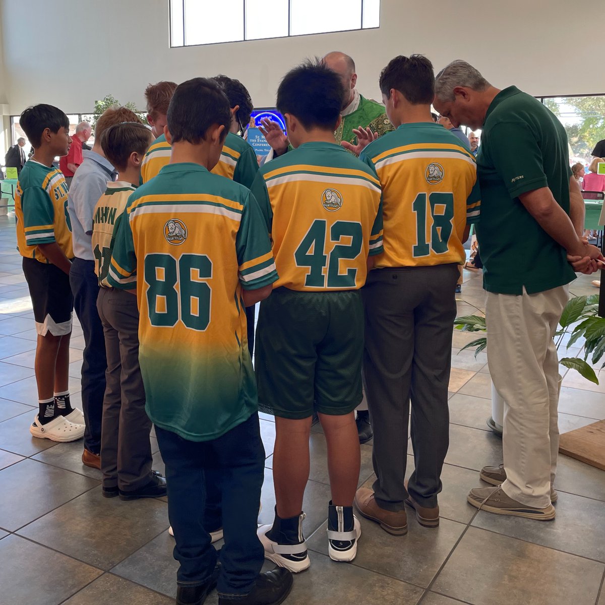 Flag football players got a special blessing from Fr. Jason before their first game of the season! #GoLions