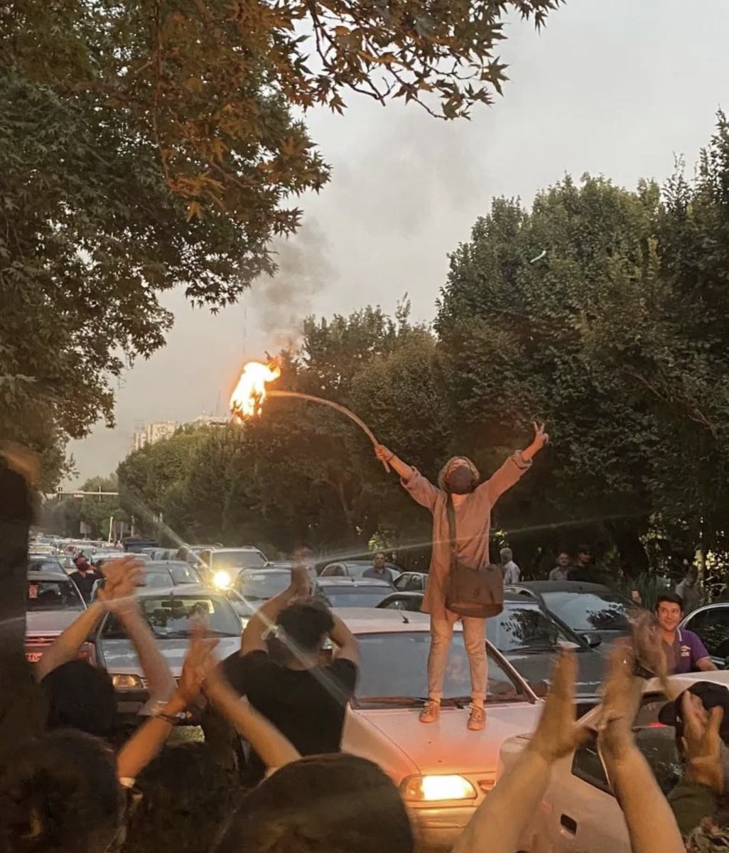 This is Iran today. A woman proudly burning the most visible symbol of religious dictatorship; compulsory hijab. Hijab police killed #MahsaAmini but now there are millions of Mahsa in Iran who are shouting NO to Forced hijab NO to gender apartheid regime. #مهسا_امینی