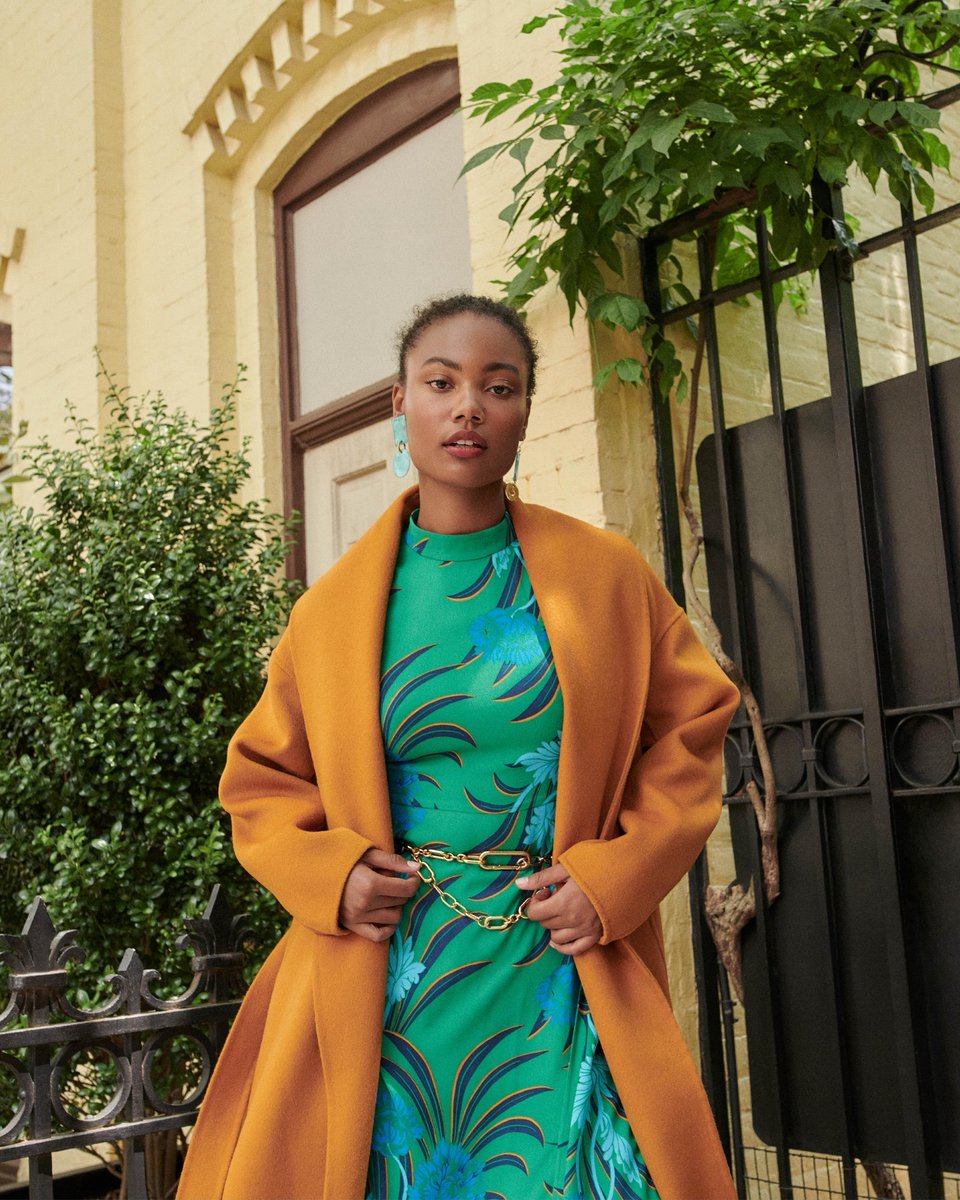 DVF's tweet image. We design our collections with a singular color palette so that our pieces can live in the same closet and create endless outfit combinations. (Notice how the Nella dress' leaf shadows are the same orange as the Nico coat?)