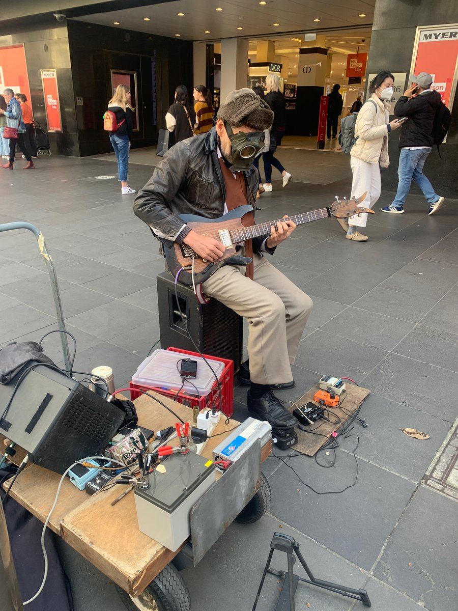 Busker in Melbourne is shredding Pink Floyd while simultaneously preparing for the apocalypse. Love it