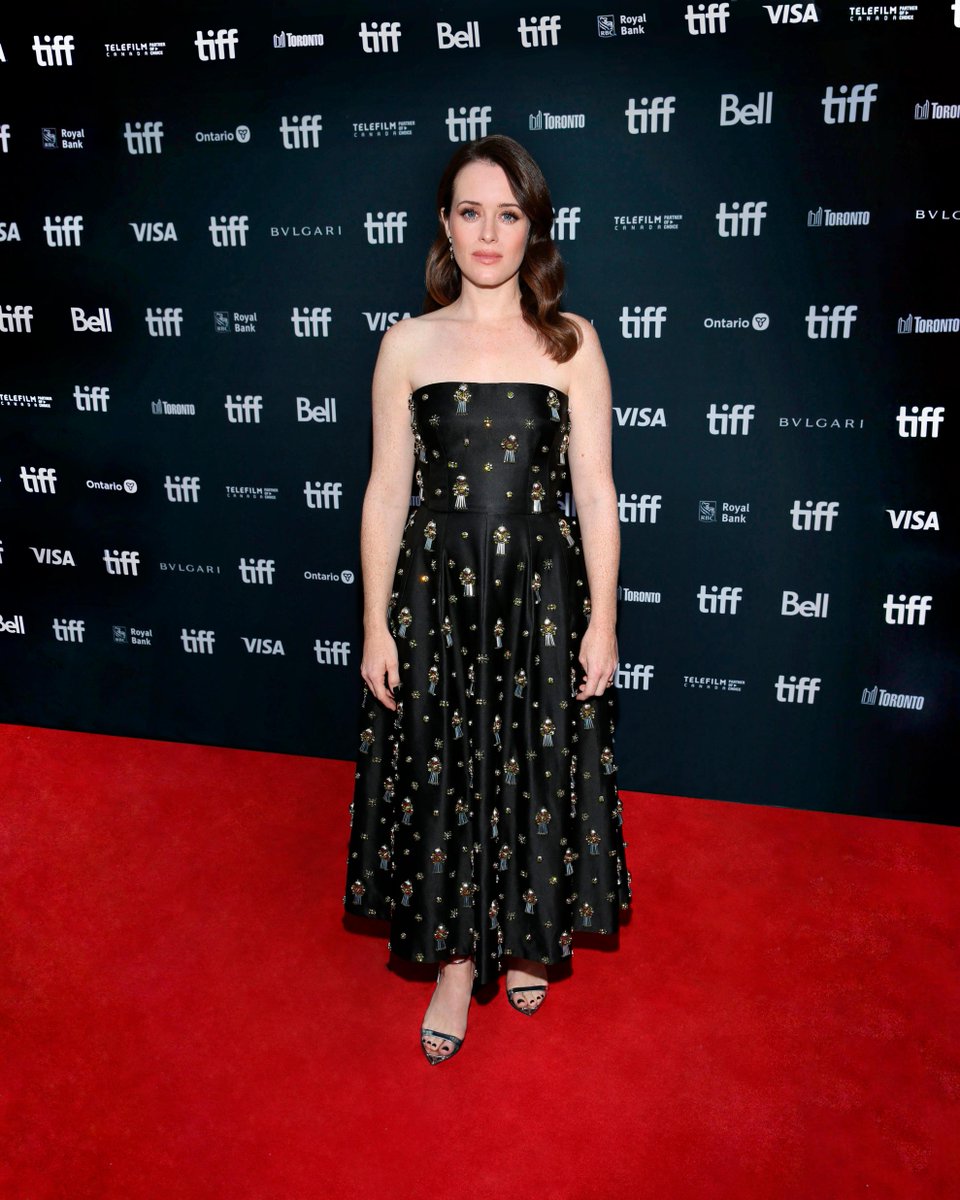Prada's tweet photo. Claire Foy wore a #Prada double black satin dress embellished with an all-over embroidery of applied stones and silver sandals with enameled metal logo triangle while attending the ‘Women Talking’ premiere during the Toronto International Film Festival.

#PradaPeople #TIFF22 https://t.co/mLjyQ0Yzin