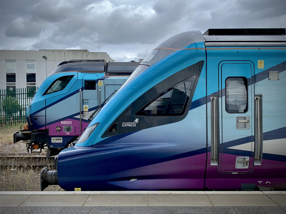 miles_chains's tweet photo. An overcast day, but I couldn’t resist. Side by side at York, Class 68 and DT together. 68021 ‘Tireless’ sits in the maintenance sidings with TP04, whilst DT 12808 (TP08) gets ready to leave for Scarborough with 68020 propelling. #Class68 #Caterpillar #Mk5a #York #Trainspotting https://t.co/vhJUmD180W