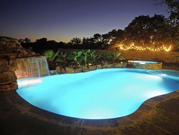 Lighting makes all the difference when designing a custom pool. #AustinPoolBuilders #AustinSwimmingPools #ReliantPools