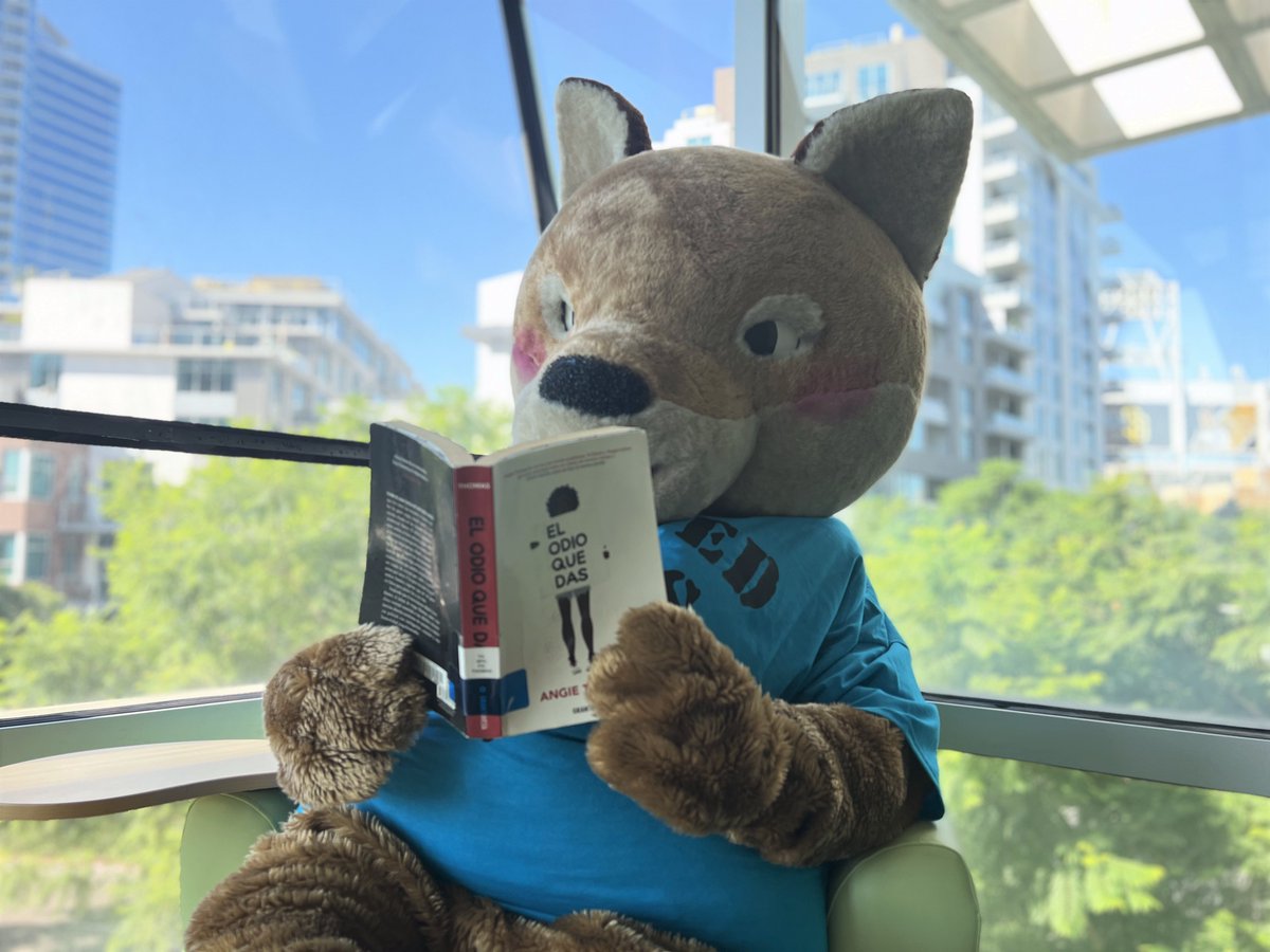 SDPublicLibrary's tweet photo. #5 "The Hate U Give" by Angie Thomas was "banned and challenged for profanity, violence & because it was thought to promote an anti-police message & indoctrination of a social agenda.” #OdiTheCoyote loves that we have it in Spanish and other languages! https://t.co/n8xgpI3PJ1 https://t.co/gGluxrVIkK