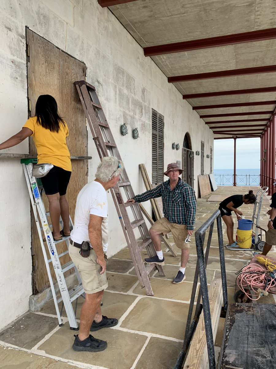 NatlMuseumBDA's tweet photo. With #HurricaneFiona approaching Bermuda, the NMB team is busy prepping the property (pictured here, Head of Facilities Andrew Harris and volunteers work on boarding up Commissioner's House to protect it from high winds). The Museum will be OPEN until it is no longer safe (1/2) https://t.co/lVfxjeXXrz